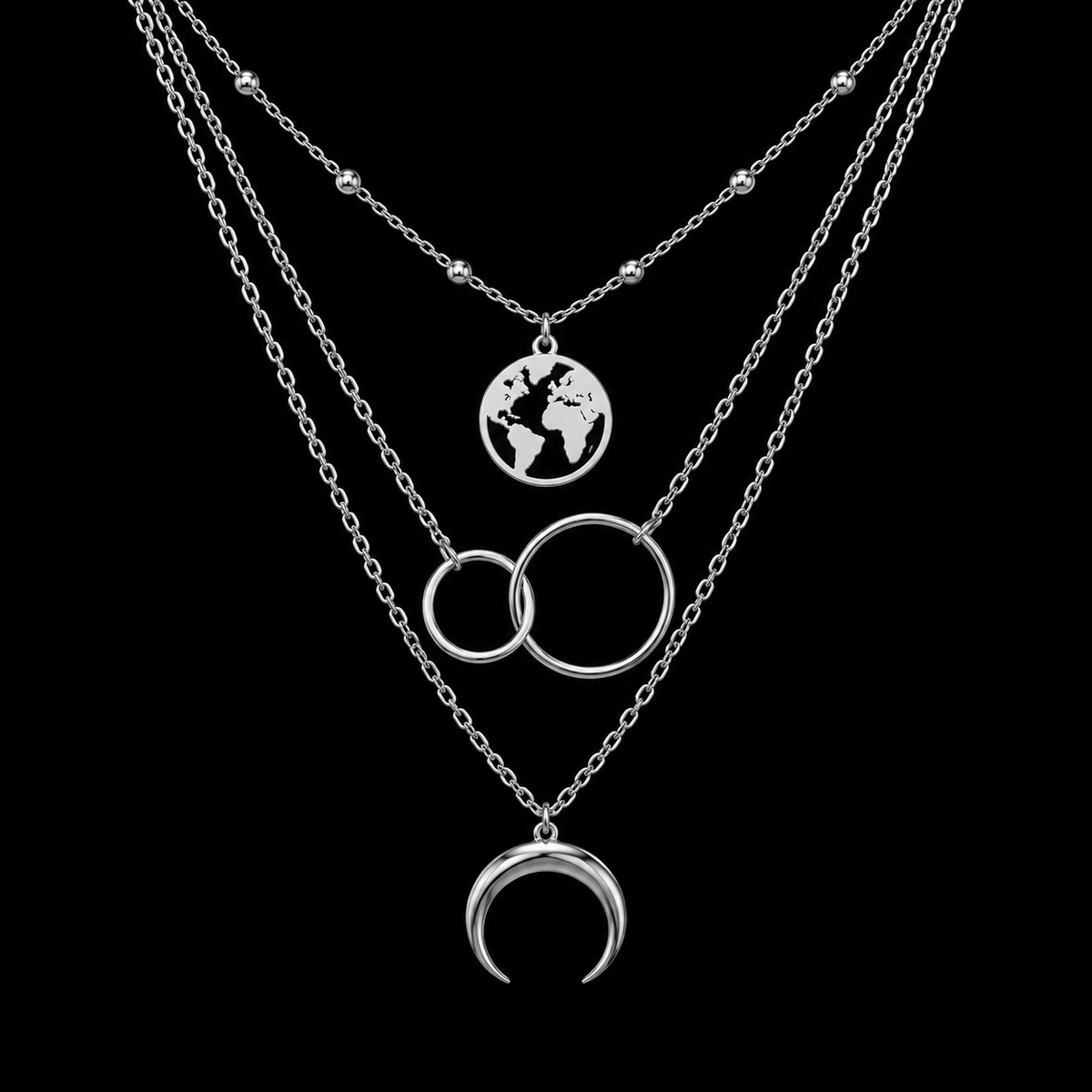Silver layered moon and world map necklace on black background